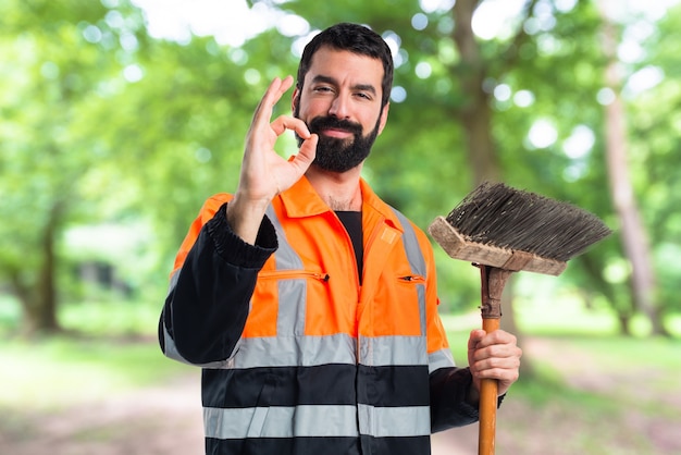 Garbage man making OK sign on unfocused background