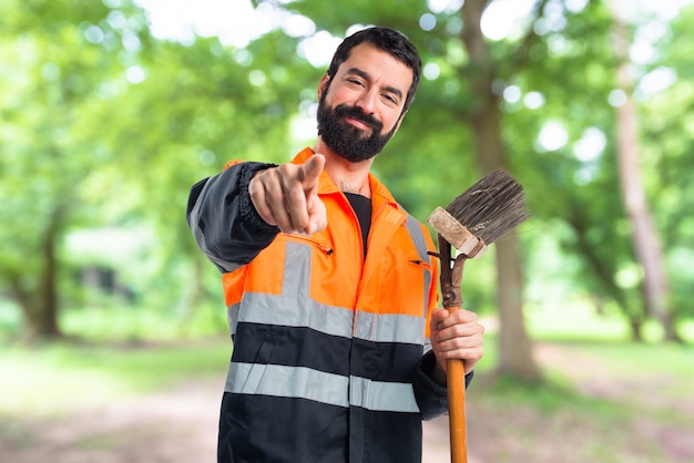 Garbage man pointing to the front on unfocused background