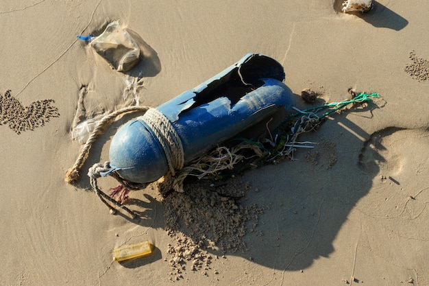 Garbage Plastic and bottles spill are left on the beach as waste polluting nature Plastic is hard to degrade destroy the ecosystem World environment day concept