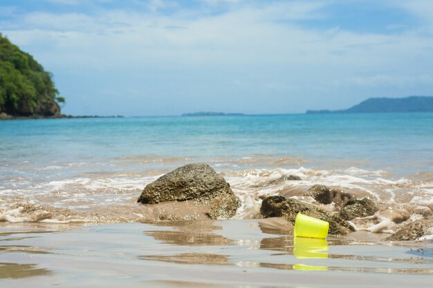 Garbage a plastic cup at the beach recycling