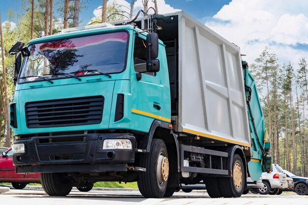 A garbage truck picks up garbage in a residential area Loading mussar in containers into the car Separate collection and disposal of garbage Garbage collection vehicle