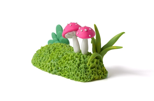 Garden bushes with fuchsia mushrooms made of plasticine Natural landscape design elements of clay