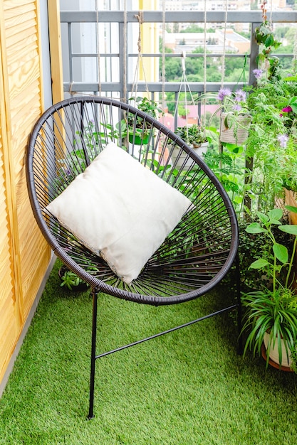 garden chair with pillow on balcony patio at home with house plants flowers