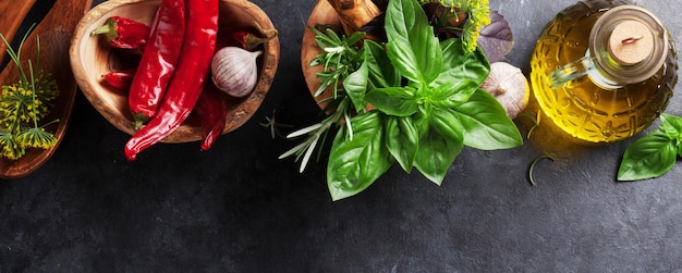 Garden herbs in mortar oil and chili