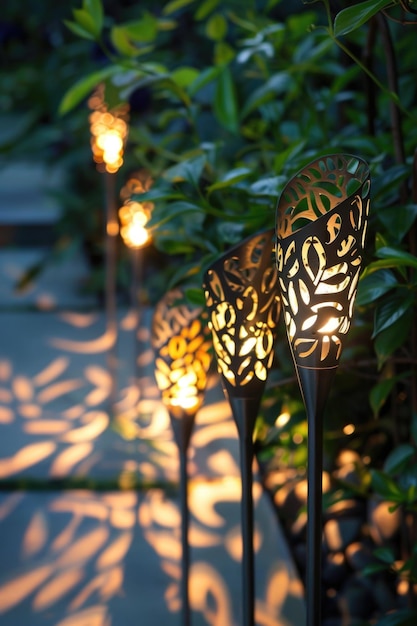 Photo garden pathway with decorative solar torch lights illuminating lush green foliage at dusk