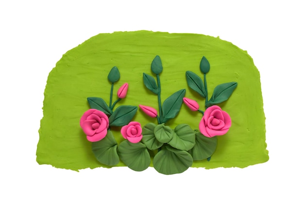 Garden roses with large leafy bushes made of plasticine Red roses isolated on white background