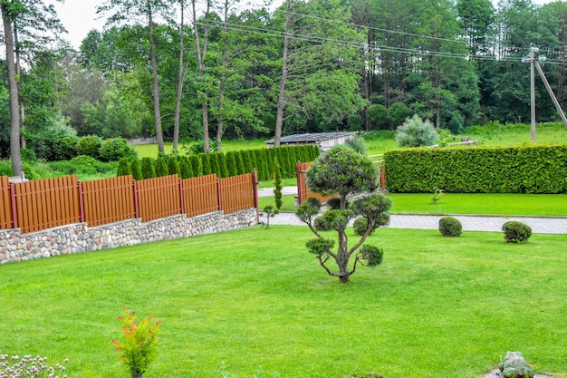 a garden with a fence and a garden with a fence in the background