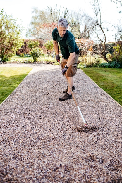 Gardener is working in beautiful English garden