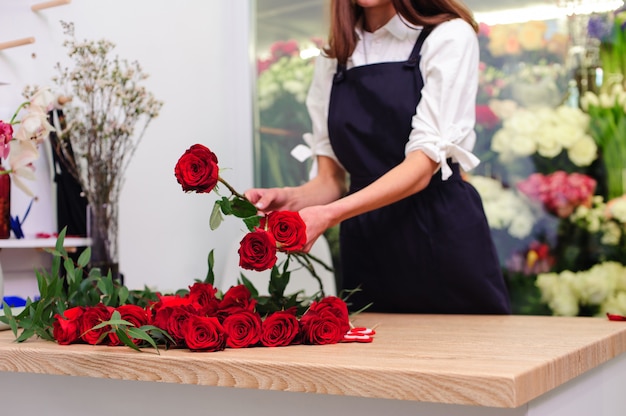 Gardener's in the flower shop make bouquet. Lifestyle flower shop. Beautiful flower composition. Detail.