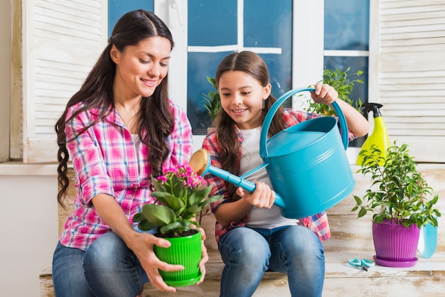 Gardening concept with mother and daughter