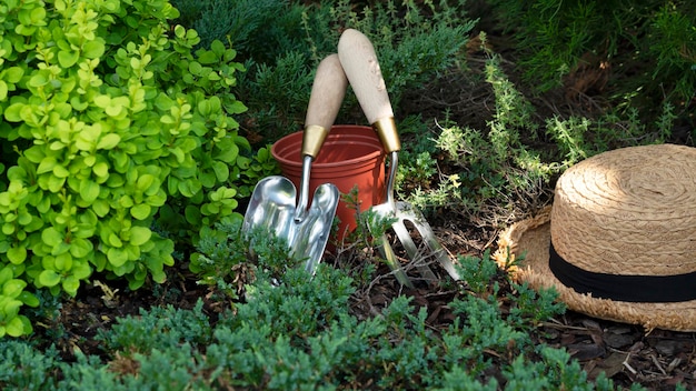 Photo gardening equipment flower pot trowel or shovel and straw hat in the garden farm background