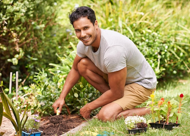 Gardening is so relaxing and rewarding Portrait of a handsome young man working in his garden