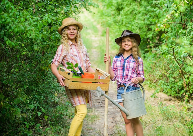 Gardening teaching life cycle process. Summer at countryside. Kids girls with tools for gardening. Gardens great place cultivate meaningful and fun learning experience for children. Gardening basics.