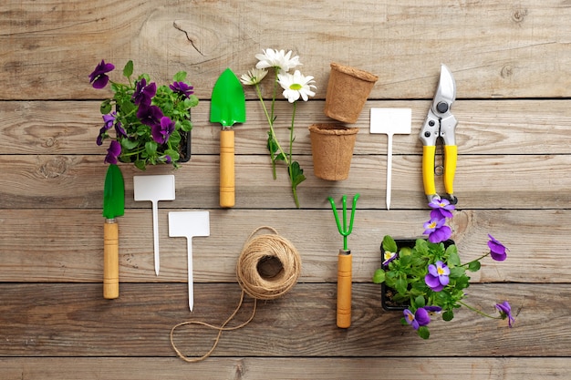 Gardening tools on wooden table.