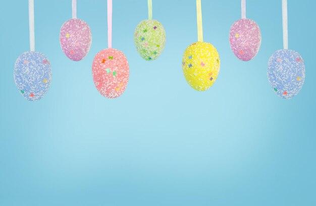 Garland of easter eggs on a blue background for your text