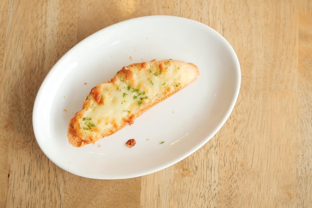 A garlic bread on a plate on table