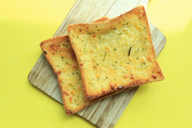 Garlic bread on yellow background