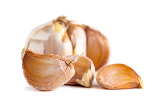 Garlic bulbs and cloves isolated on white surface