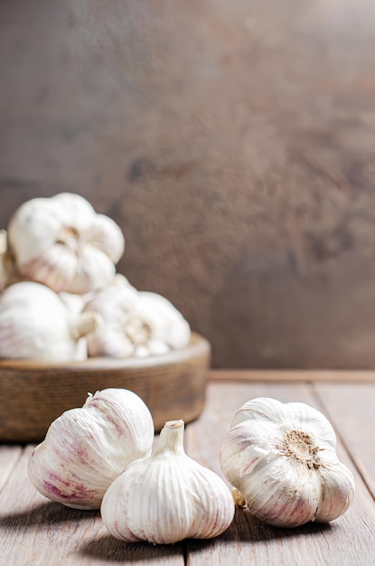 Garlic bulbs on a wooden background Copy space