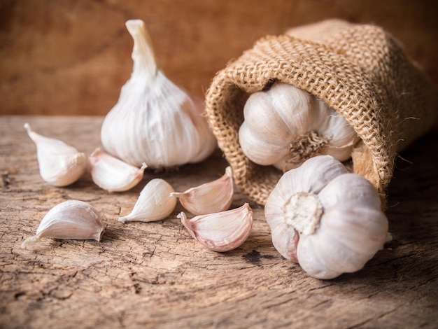 Garlic cloves and bulbs on rustic wooden table