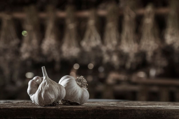 Garlic Cloves and Garlic Bulb on vintage wood background.