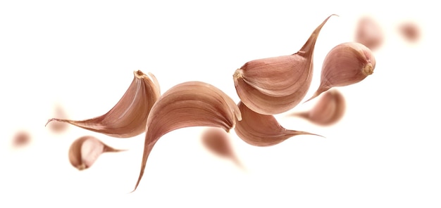 Garlic cloves levitate on a white background