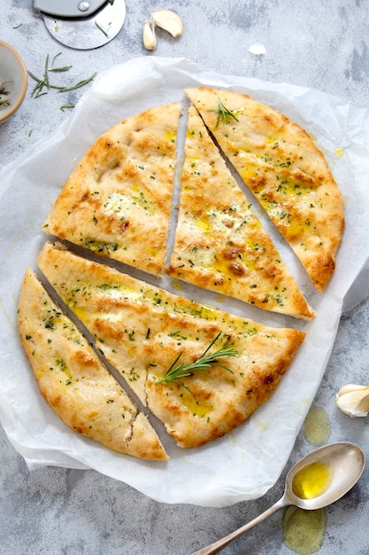 Garlic foccacia bread. Freshly baked flat garlic bread with olive oil and herbs.