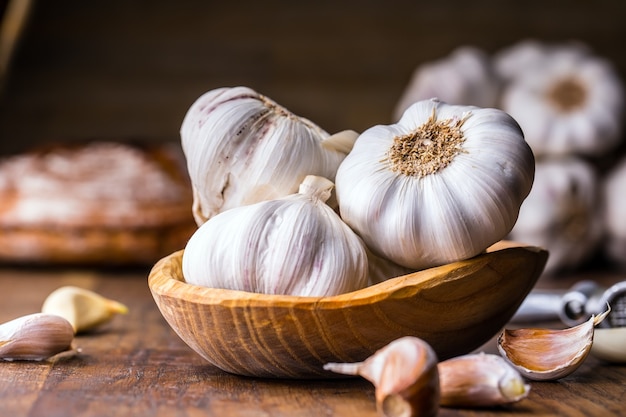 Garlic. Garlic Cloves and Garlic Bulb in vintage wooden bowl.