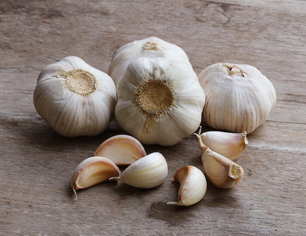 Garlic heads closeup on a wood table garlic is herb for reduce fat in blood