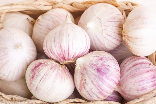 Garlic heads in a wicker basket close up