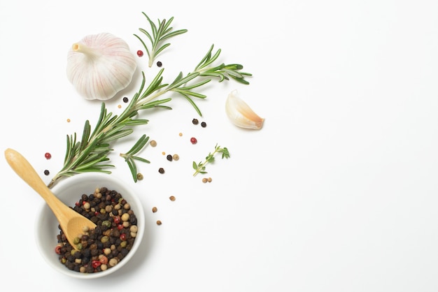 Garlic, rosemary, bay leaves, allspice and pepper isolated on white space. Flat lay. Top view