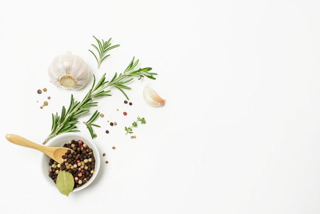 Garlic, rosemary, bay leaves, allspice and pepper isolated on white space. Flat lay. Top view