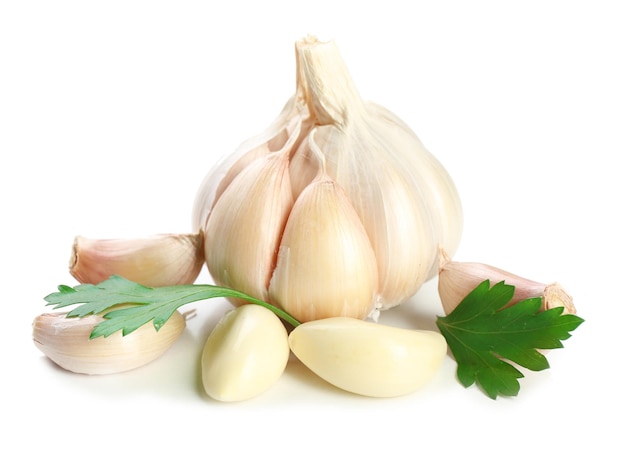 Garlic with leaves of parsley isolated on white