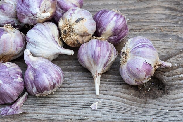 Garlic on wooden vintage background Seedlings for planting garlic