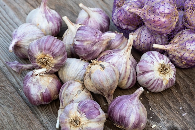 Garlic on wooden vintage background Seedlings for planting garlic