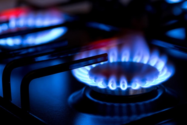 Gas burner with burnig methane on dark background