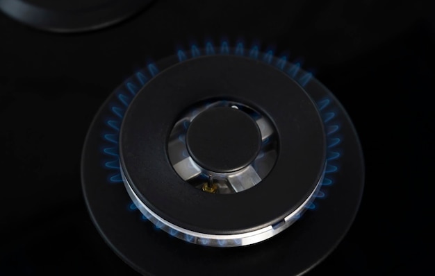 Gas flame closeup Natural gas burns with a blue flame on the stove Concept of gasification