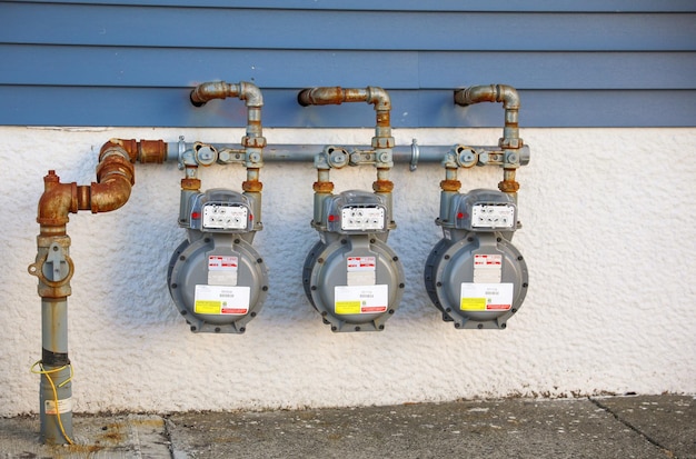 Gas meter on a wall with the chinese writing on the front.