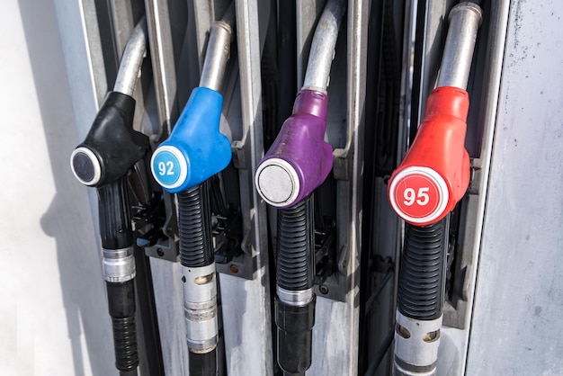 Gas and petrol station Guns for refueling at a gas station Detail of a petrol pump different colors in gas station Close up on fuel nozzle in oil dispenser with gasoline and diesel