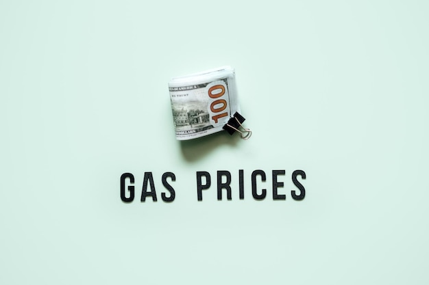 Gas prices energy crisis concept gasoline prices rising stack of dollar bills and text gas prices on