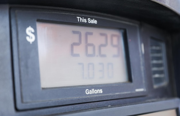 gas pump stands outside a hospital representing rising fuel costs impacting healthcare budgets ess