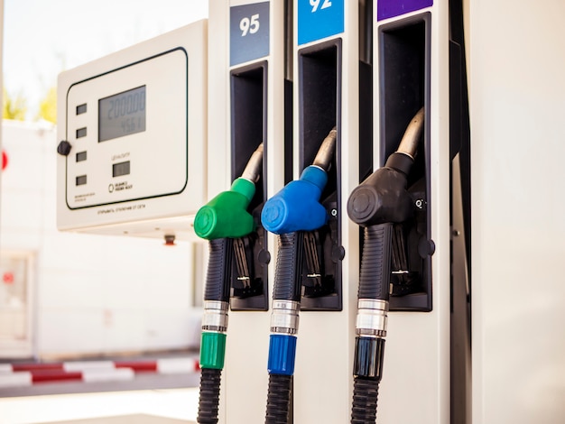 Gas station close up colourful fuel pumps nozzle at gas