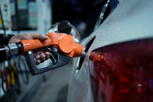 Gas station Worker hand with gas station gun