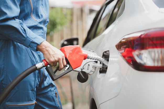 Gas station workers are refueling cars fuel consumption gasolinepowered cars fluctuating oil prices using alternative fuels for driving