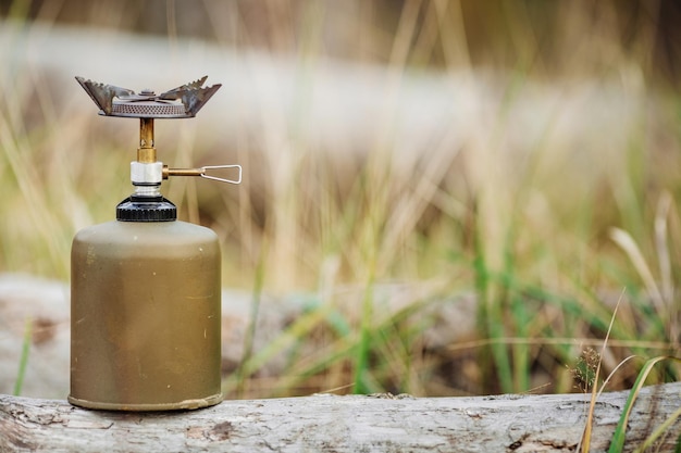 Gas stove on wood on forest background Lunch during the journey to the wild Camping lifestyle