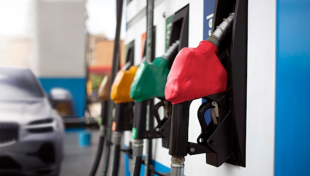 Gasoline Pump nozzles at the gas station with car Head fuel vehicle refueling facility in world oil situation