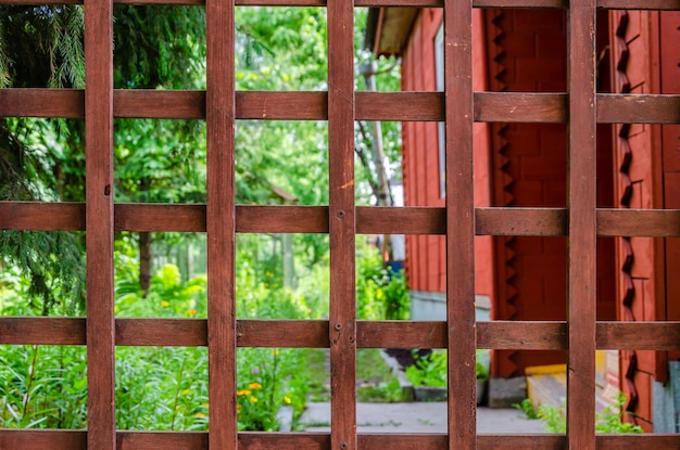 The gate to the house is made of thin wooden slats.