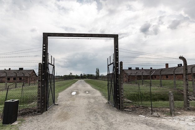 Gates and barbed wire fence, German concentration camp Auschwitz II, Poland.