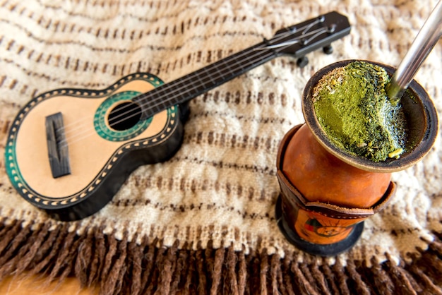 Gaucho tradition poncho guitar and chimarrao of yerba mate tea