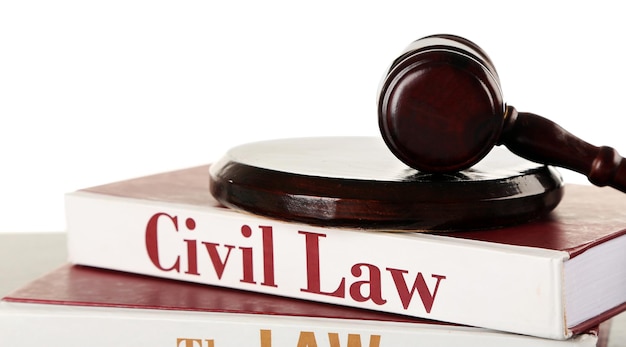 Gavel and books on wooden table on white background